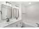 Bathroom featuring double sinks, a jetted tub, and modern fixtures providing space and elegance at 1631 Wilford Ln, Indianapolis, IN 46229