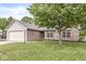 Inviting single-story home with a brick facade, attached garage, and green lawn at 1631 Wilford Ln, Indianapolis, IN 46229