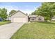 Attractive single-story home featuring a brick facade, attached garage, and well-maintained lawn at 1631 Wilford Ln, Indianapolis, IN 46229