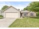 Charming single-story home featuring a brick facade, attached garage, and well-maintained lawn at 1631 Wilford Ln, Indianapolis, IN 46229