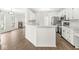 Open kitchen features white cabinets, stainless appliances, and breakfast bar overlooking the living area at 1631 Wilford Ln, Indianapolis, IN 46229