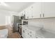 Kitchen showcasing stainless steel appliances, light countertops, and white cabinetry at 1631 Wilford Ln, Indianapolis, IN 46229