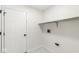 Practical laundry area with marble-patterned tile flooring and available shelving at 1631 Wilford Ln, Indianapolis, IN 46229