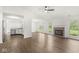 Spacious living room featuring hardwood floors, fireplace, and an open layout to the kitchen at 1631 Wilford Ln, Indianapolis, IN 46229