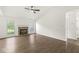 Open-concept living room featuring hardwood floors, fireplace, and plenty of natural light at 1631 Wilford Ln, Indianapolis, IN 46229