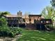 Expansive backyard with a multi-tiered deck, a stone chimney, and well-manicured lawn at 177 Wellington Pkwy, Noblesville, IN 46060