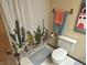Charming bathroom with a cactus-themed shower curtain and warm-toned walls provides functional style at 177 Wellington Pkwy, Noblesville, IN 46060