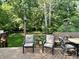 Comfortable seating area with a dining table, chairs, and a wooded backdrop at 177 Wellington Pkwy, Noblesville, IN 46060
