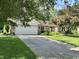 Charming stone and siding home with a well-manicured lawn, long driveway, and mature trees at 177 Wellington Pkwy, Noblesville, IN 46060