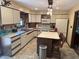 Kitchen featuring white cabinets, an island with seating and modern appliances at 177 Wellington Pkwy, Noblesville, IN 46060