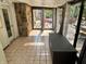 Inviting sunroom with tiled floor, stone wall, and views of the outdoor deck at 177 Wellington Pkwy, Noblesville, IN 46060