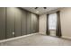 Inviting bedroom with carpet, modern gray accent wall, and a window providing natural light at 2016 Central Ave, Indianapolis, IN 46202