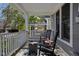 Relaxing front porch features rocking chairs and an outdoor rug, perfect for enjoying the neighborhood views at 2016 Central Ave, Indianapolis, IN 46202