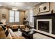 Bright living room showcasing a fireplace, a cozy sofa, and natural light, creating a welcoming and comfortable space at 2016 Central Ave, Indianapolis, IN 46202