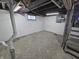 This is an unfinished basement that has painted white walls and a single window at 2035 S Pennsylvania St, Indianapolis, IN 46225