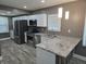 Modern kitchen with stainless steel appliances, granite countertops, and a breakfast bar at 2035 S Pennsylvania St, Indianapolis, IN 46225