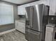 Modern kitchen with stainless steel refrigerator, granite countertops, and white cabinets at 2035 S Pennsylvania St, Indianapolis, IN 46225