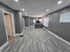 This is a well-lit living room featuring luxury vinyl plank flooring and neutral gray walls at 2035 S Pennsylvania St, Indianapolis, IN 46225