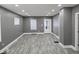 Spacious living room with modern gray walls, wood-look floors, and recessed lighting at 2035 S Pennsylvania St, Indianapolis, IN 46225