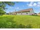 Expansive backyard featuring lush green lawn and the back of the home at 2145 W Autumn Ln, Columbus, IN 47201