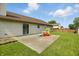 Lovely backyard with a concrete patio, play structure, grassy area and partial fencing for outdoor enjoyment at 2145 W Autumn Ln, Columbus, IN 47201