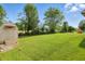 Spacious backyard features a storage shed on the left and play structure in the background at 2145 W Autumn Ln, Columbus, IN 47201