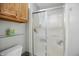 Bathroom featuring a shower/tub combo with a frosted sliding door and white tile at 2145 W Autumn Ln, Columbus, IN 47201