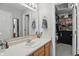 Well-lit bathroom features a single sink vanity, framed mirror, and access to a closet at 2145 W Autumn Ln, Columbus, IN 47201