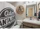 Well-lit bathroom featuring a modern vanity with granite countertop and decorative shower curtain at 2145 W Autumn Ln, Columbus, IN 47201