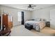 Well-lit bedroom with neutral carpet, a ceiling fan, and a comfortable bed at 2145 W Autumn Ln, Columbus, IN 47201