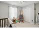 Cozy bedroom with a rocking chair, toys, and closet with folding doors at 2145 W Autumn Ln, Columbus, IN 47201