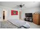Bright bedroom features neutral walls, ceiling fan, ensuite bathroom, and a flat screen TV at 2145 W Autumn Ln, Columbus, IN 47201