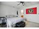 Bright bedroom features neutral walls, ceiling fan, ensuite bathroom, and a Black Hawks wall decoration at 2145 W Autumn Ln, Columbus, IN 47201
