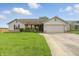 Charming single-story home with a well-manicured lawn and a two-car garage at 2145 W Autumn Ln, Columbus, IN 47201