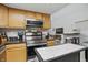 Bright eat-in kitchen with stainless steel appliances, black countertops, and an island at 2145 W Autumn Ln, Columbus, IN 47201