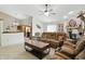 Cozy living room featuring a brick fireplace, comfortable seating, and a modern ceiling fan at 2145 W Autumn Ln, Columbus, IN 47201