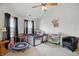 Comfortable living room with ample natural light, neutral carpet, and ceiling fan at 2145 W Autumn Ln, Columbus, IN 47201