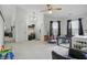 Open-concept living room offering plenty of natural light with neutral carpet and modern ceiling fan at 2145 W Autumn Ln, Columbus, IN 47201