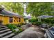 Secluded backyard with multiple seating areas, lush gardens, and charming string lights at 224 N Pennsylvania St, Greenfield, IN 46140