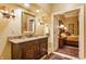 Elegant bathroom features a wooden vanity, granite countertop, and ornate sconces at 224 N Pennsylvania St, Greenfield, IN 46140