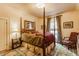 Cozy bedroom featuring a four-poster bed, plush rug, and tranquil ambiance at 224 N Pennsylvania St, Greenfield, IN 46140