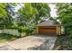 Two-car detached garage with lush landscaping and driveway at 224 N Pennsylvania St, Greenfield, IN 46140