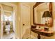 Charming hallway with decorative mirror and quaint powder room at 224 N Pennsylvania St, Greenfield, IN 46140