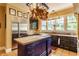 Charming kitchen featuring a center island, stainless steel fridge, and custom cabinets at 224 N Pennsylvania St, Greenfield, IN 46140