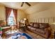 Comfortable living room with exposed beams, plush seating, and abundant natural light at 224 N Pennsylvania St, Greenfield, IN 46140
