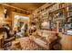 Cozy room with floor-to-ceiling bookshelves, a leather sofa, and vintage decor, creating a warm and inviting atmosphere at 224 N Pennsylvania St, Greenfield, IN 46140