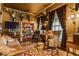 Traditional living room featuring bookshelves, deer mounts, and a view into the dining area at 224 N Pennsylvania St, Greenfield, IN 46140
