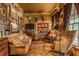 A stately living room with floor-to-ceiling bookshelves, deer mounts, and a zebra-print chair at 224 N Pennsylvania St, Greenfield, IN 46140