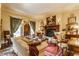 Warm and inviting living room with a fireplace, classic artwork, and comfortable seating arrangements at 224 N Pennsylvania St, Greenfield, IN 46140