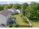 Aerial view of backyard with patio, trampoline, and well-manicured lawn at 2326 Gradison Cir, Indianapolis, IN 46214